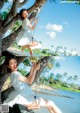 A woman in a white dress swinging on a swing.